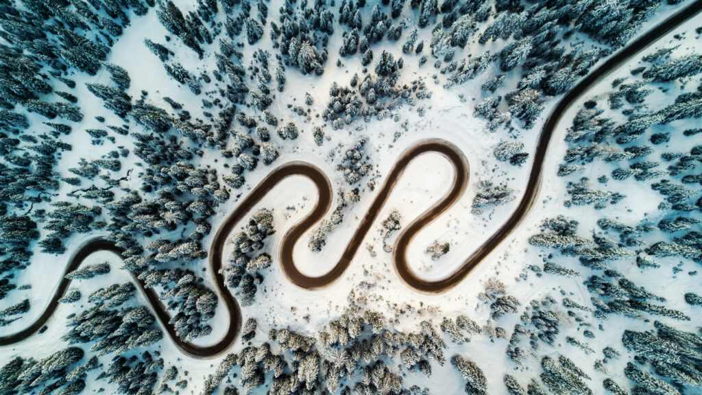 Top,Aerial,View,Of,Snow,Mountain,Landscape,With,Trees,And